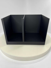 Black three-compartment organizer on a white platform with a white background
