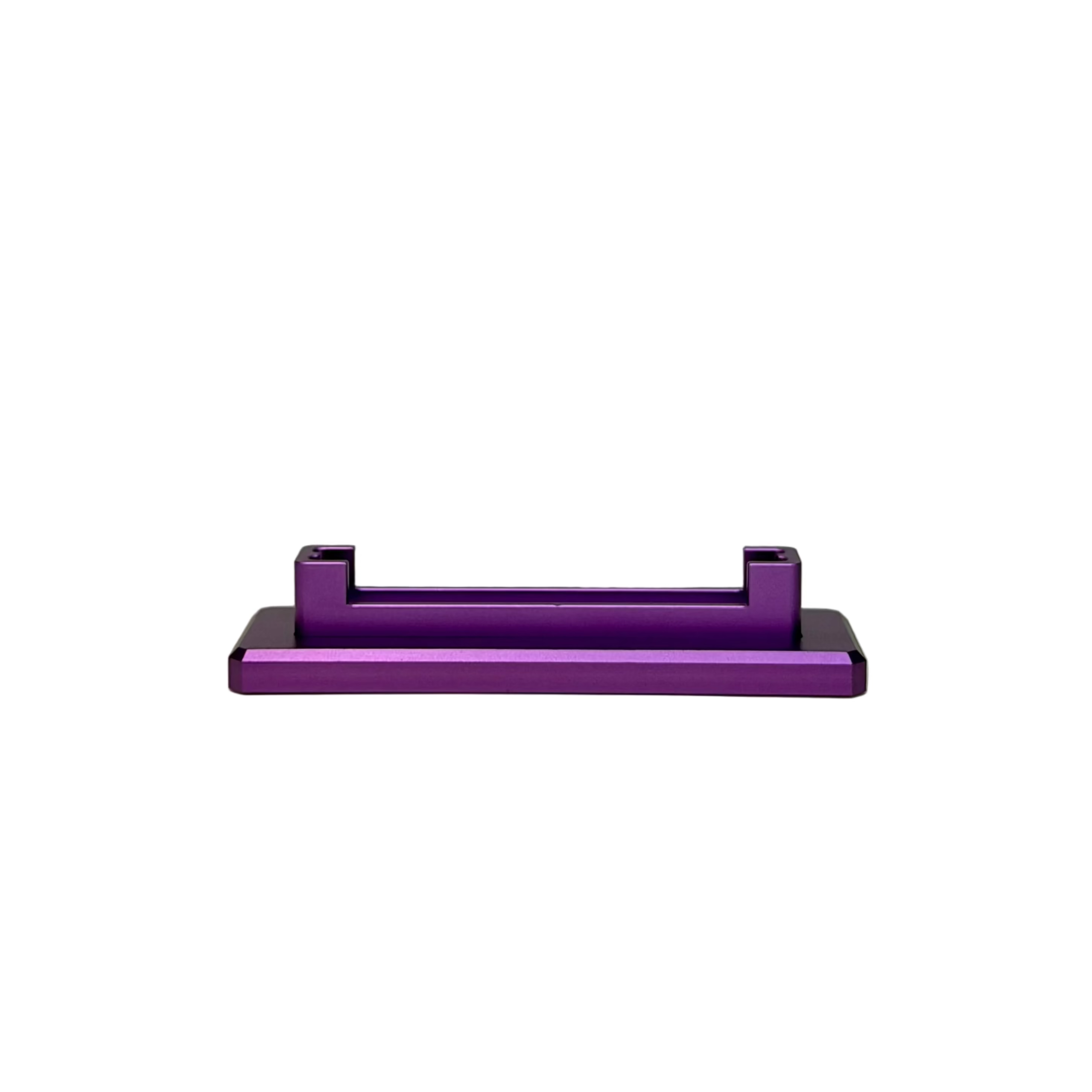 A purple anodized metal bracket or stand with a matte black base, displayed on a round white pedestal against a textured light gray background.