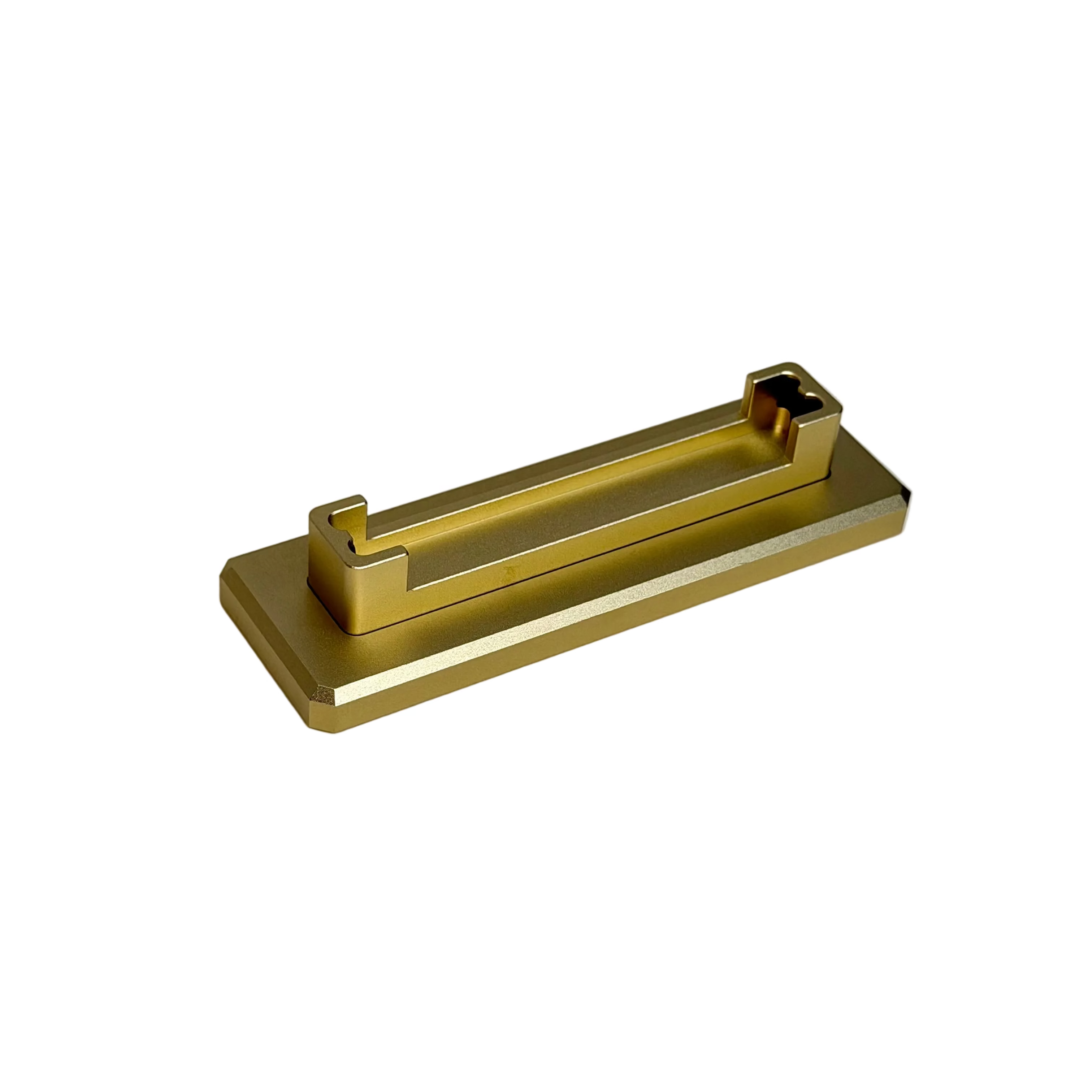 A modern rectangular gold metal pull handle with a minimalist geometric design, displayed on a round cream-colored pedestal against a white background.
